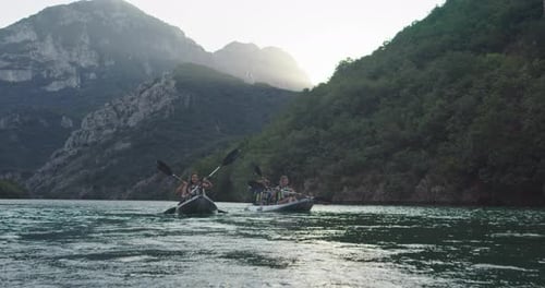 Adventurous Young Adults Kayaking on Serene Mountain Lake
