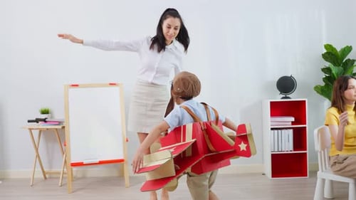 Caucasian beautiful woman teacher teaching a lesson to kid student in classroom at school.