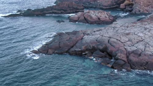 Ocean Waves Crashing on Rocky Coastline Aerial View