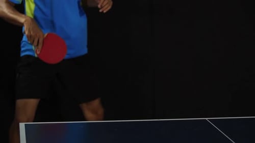Young Male Playing Tennis On Black Background