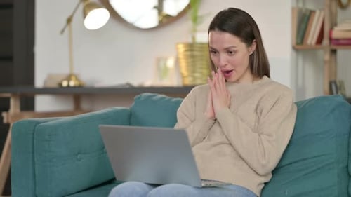 Woman Video Chatting on Laptop from Home Couch