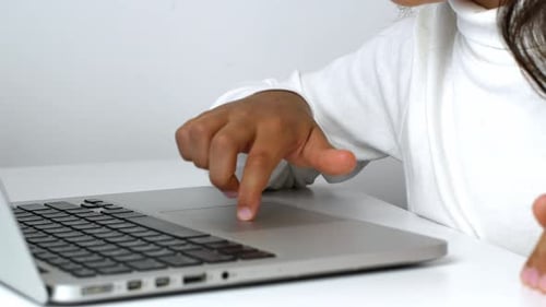 Child Using Trackpad on Silver Laptop Computer
