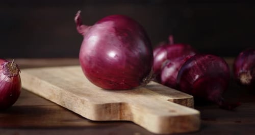 Red Onions Resting on Wooden Cutting Board