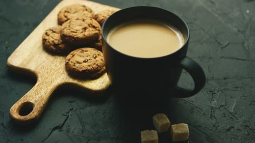 Coffee, Cookies, and Sugar Cubes on Dark Surface
