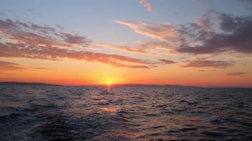 Sun Rises Over Sea Waves at Early Morning