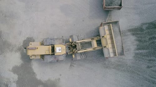 Front Loaders Working on Production of Crushed Stone, Drone Shot Top Aerial View Slow Motion