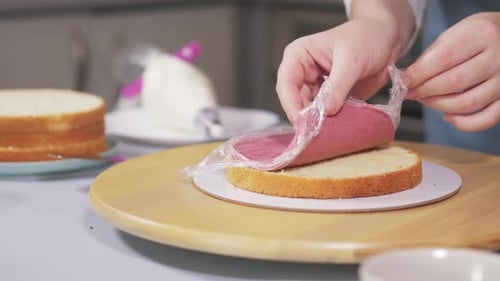 The Pastry Chef Prepares the Cake Puts the Berry Layer Between the Biscuits