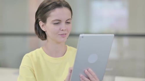 Young Woman Using Tablet Device Indoors