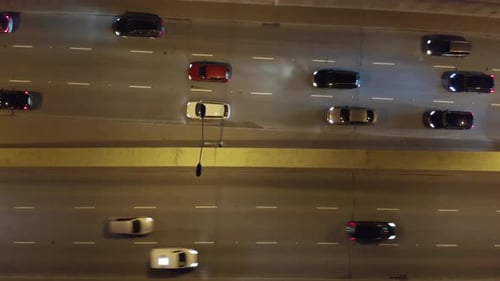 Aerial View of City at Night with Trafic and Cars Driving on the Freeway and Streets