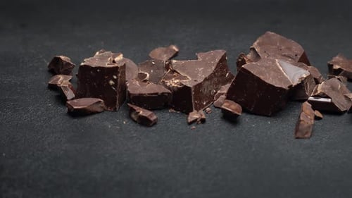 Rich Dark Chocolate Pieces on a Dark Surface