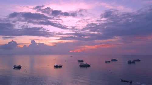 Tranquil Boats Sailing on Tropical Water at Sunset