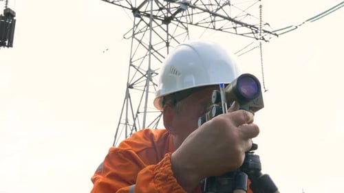 Senior Surveyor Adjusts Dumpy Level Rotating Knob and Writes