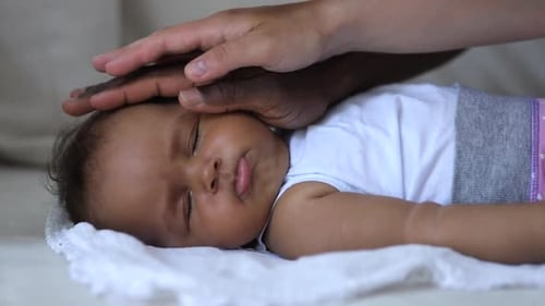 Closeup View of Multiethnic Family Touching Little Baby on Sofa at Home Room Spbi