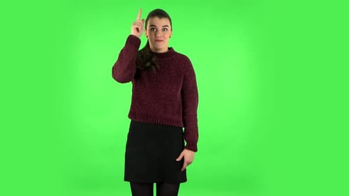 Cute Female Pointing Up Fingers. Green Screen