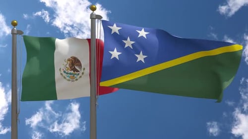 Flags of Mexico and Solomon Islands Waving Against Blue Sky