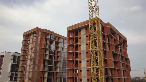 Aerial view of tall residential apartment buildings under construction. Real estate development.