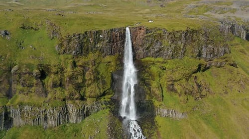 Aerial Drone Footage of Bjarnarfoss Waterfall with Its Green Cliffs in Western Iceland