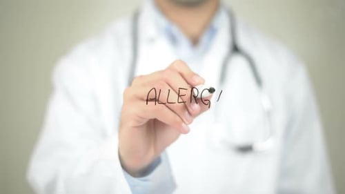 Healthcare Provider Writes the Word Allergy