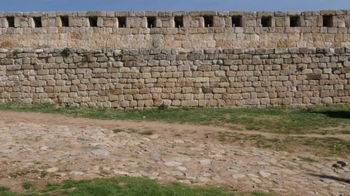 Protecting stone wall slow tilt 3840X2160 UHD footage - Old castle rampart against blue sky 4K 2160p
