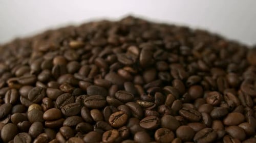 Roasted Coffee Beans Falling Onto Pile