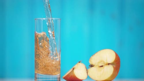 Apple juice pouring in a glass