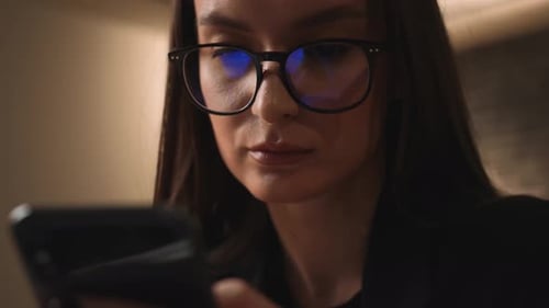 Young Woman Using Smartphone Indoors Close Up