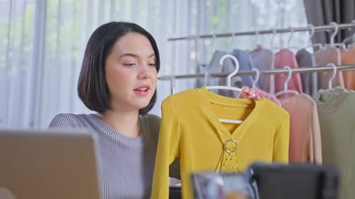 Woman Presenting Fashionable Top for Online Broadcast