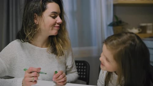Mother and Child Drawing Together at Table