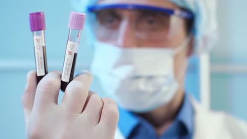 Medical Worker Holding Positive Coronavirus Blood Test Sample