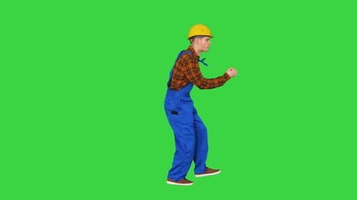 Dancing Young Engineer with Helmet After Work on a Green Screen, Chroma Key