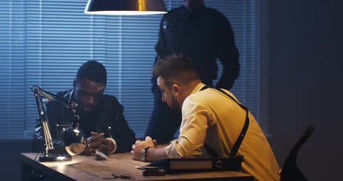 Intense Interrogation Room Scene with Two Men