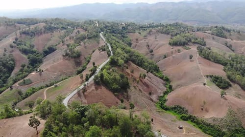 Aerial top view of sky road over top of mountain green jungle, Transportation road across mountain