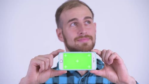 Man Holds Smartphone with Green Screen, Close-up