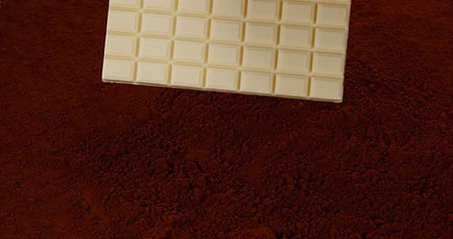 White Chocolate Bar Resting On Cocoa Powder