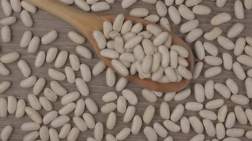 Pile of White Beans with Wooden Spoon