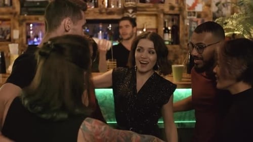 Multiethnic Friends Dancing and Hugging at Bar