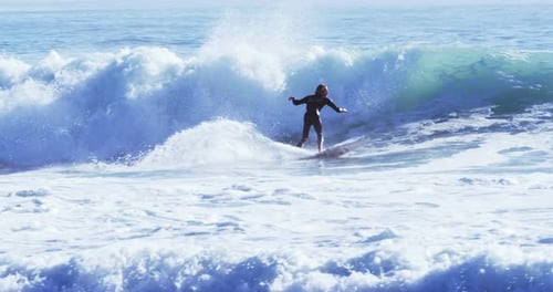 Surfers surfing in sea