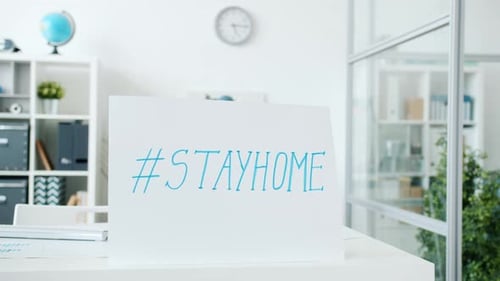 Empty Office Room with No People During Covid-19 Pandemic and Banner Stayhome Hashtag