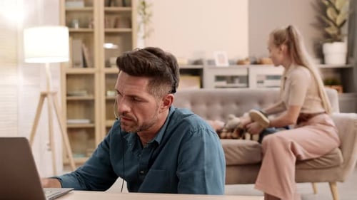 Man Working and Family Playing