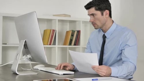 Man Working At Computer in Office