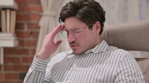 Portrait of Middle Aged Man having Headache at Home