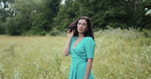 Woman in Dress Posing in Grassy Field