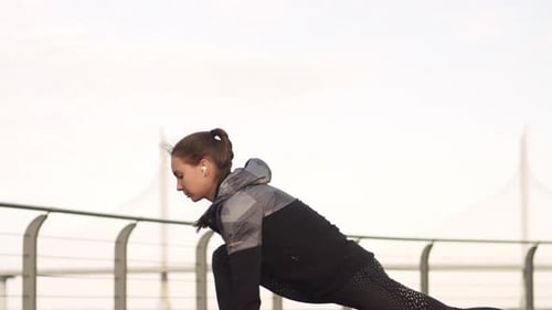 Young Woman Stretching Before Workout Outdoors