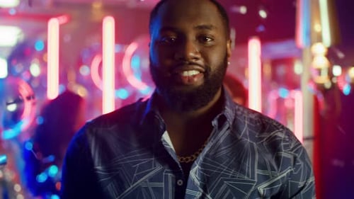 African American Man Having Rest in Club. Afro Guy Looking at Camera at Party