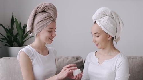 Women Friends Apply Face Cream