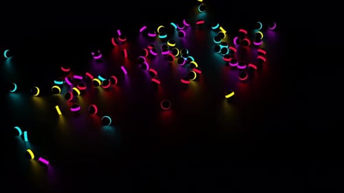 Viele kleine dunkle Kugeln mit bunten Neonstreifen, die herunterfallen und in alle Seiten rollen