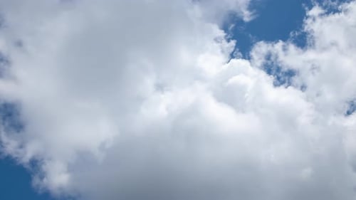 Close-up Fluffy White Clouds Moving Fast in Time-lapse. Daylight, Cloudy Heaven Background
