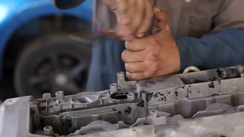 Mechanic Repairs Car Engine with Socket Wrench
