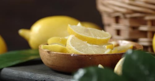 Sliced Lemon in a Bowl on a Cutting Board Rotates Slowly