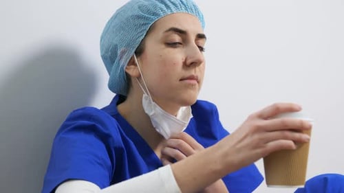 Medical Worker in Scrubs Drinking Coffee